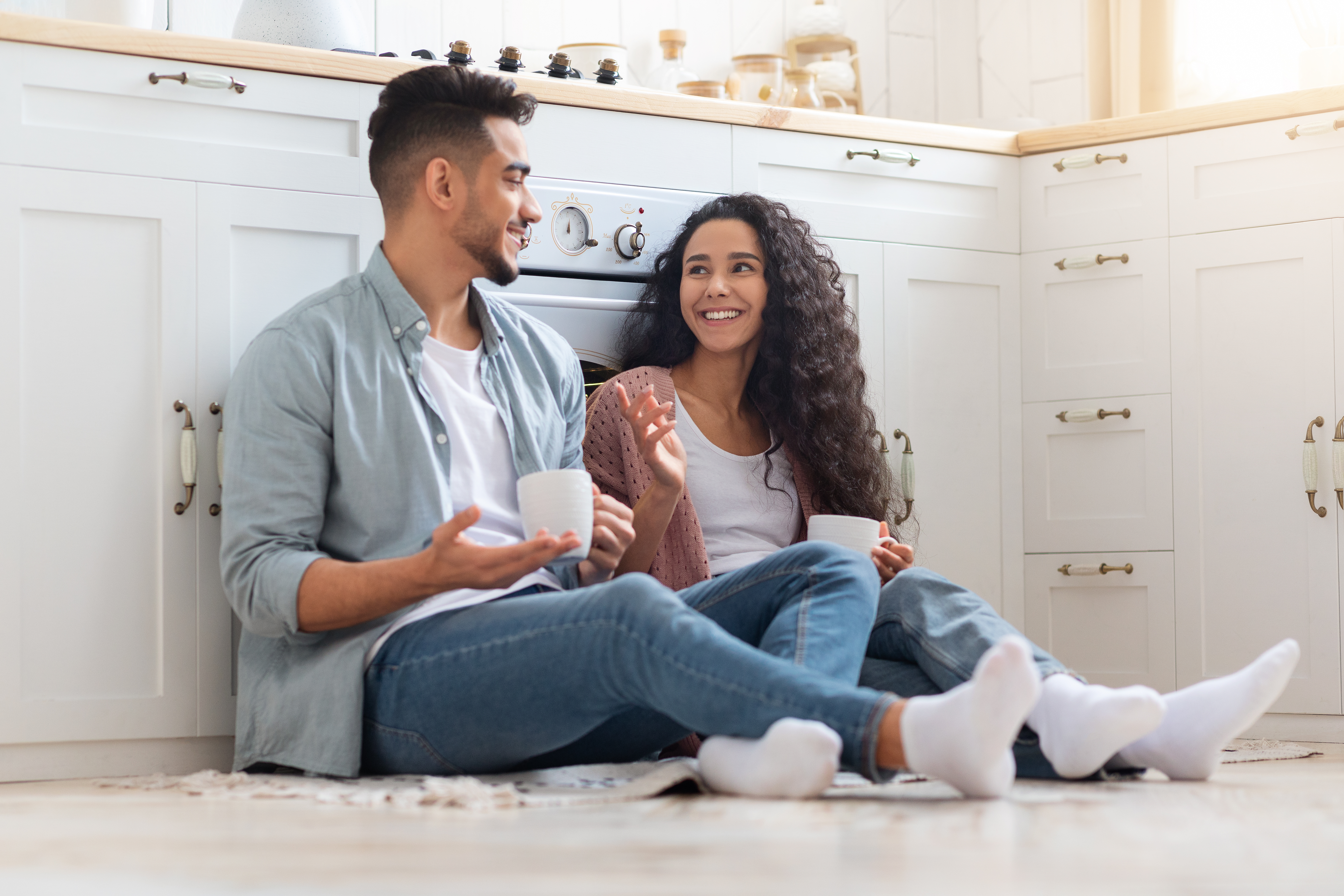 man-and-woman-sitting-on-floor-drinking-coffee