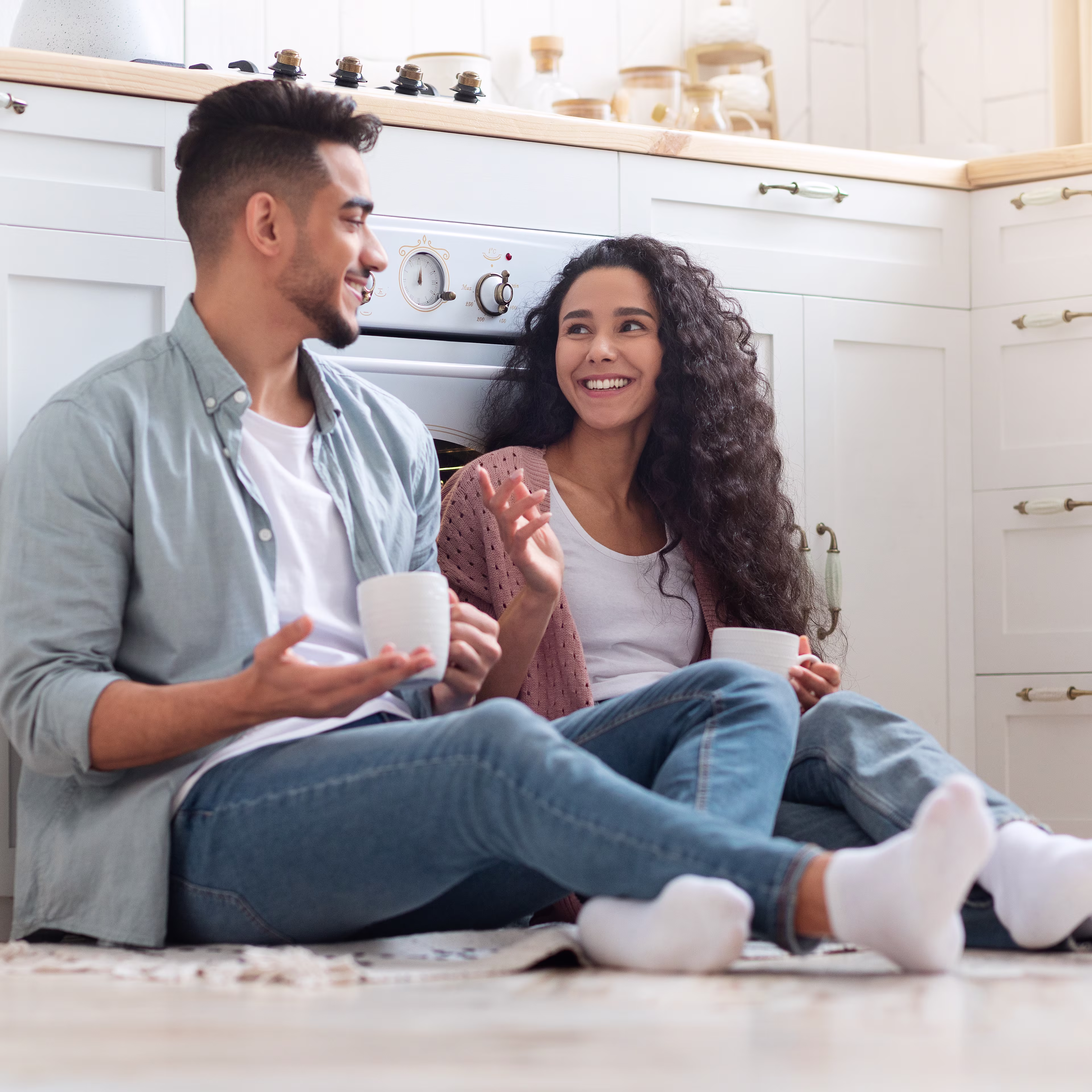 man-and-woman-sitting-on-floor-drinking-coffee