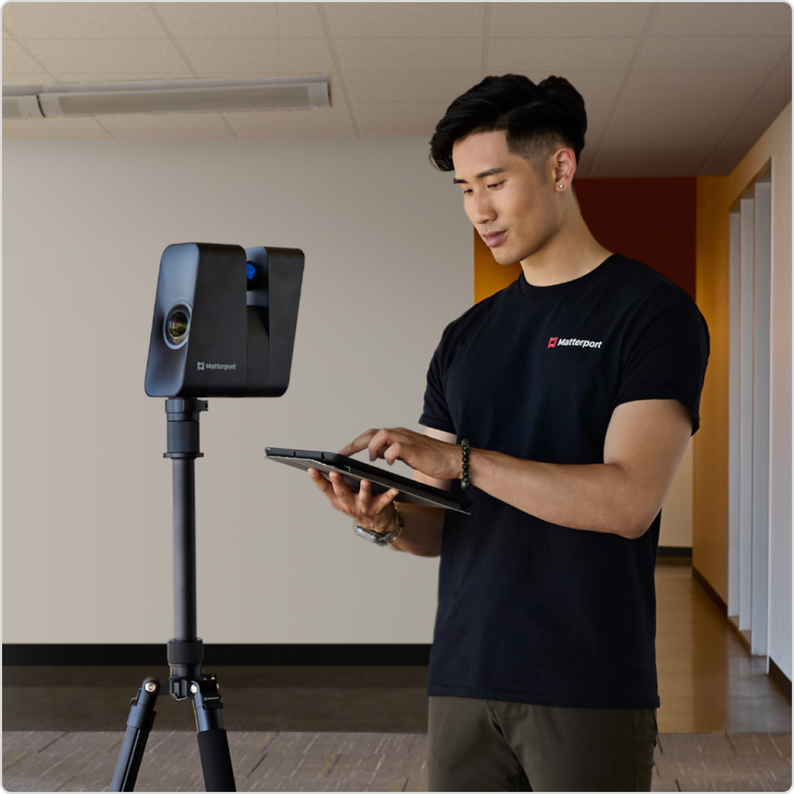A man scanning a space with a Matterport Pro3 camera