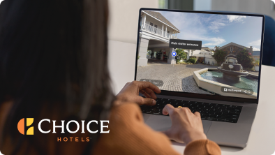 A woman working with a Matterport model on her laptop, with the Choice Hotels logo in the corner.