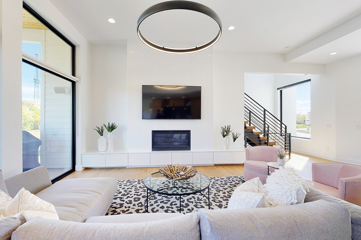 HDR photo of living room with spotted rug, couches and TV