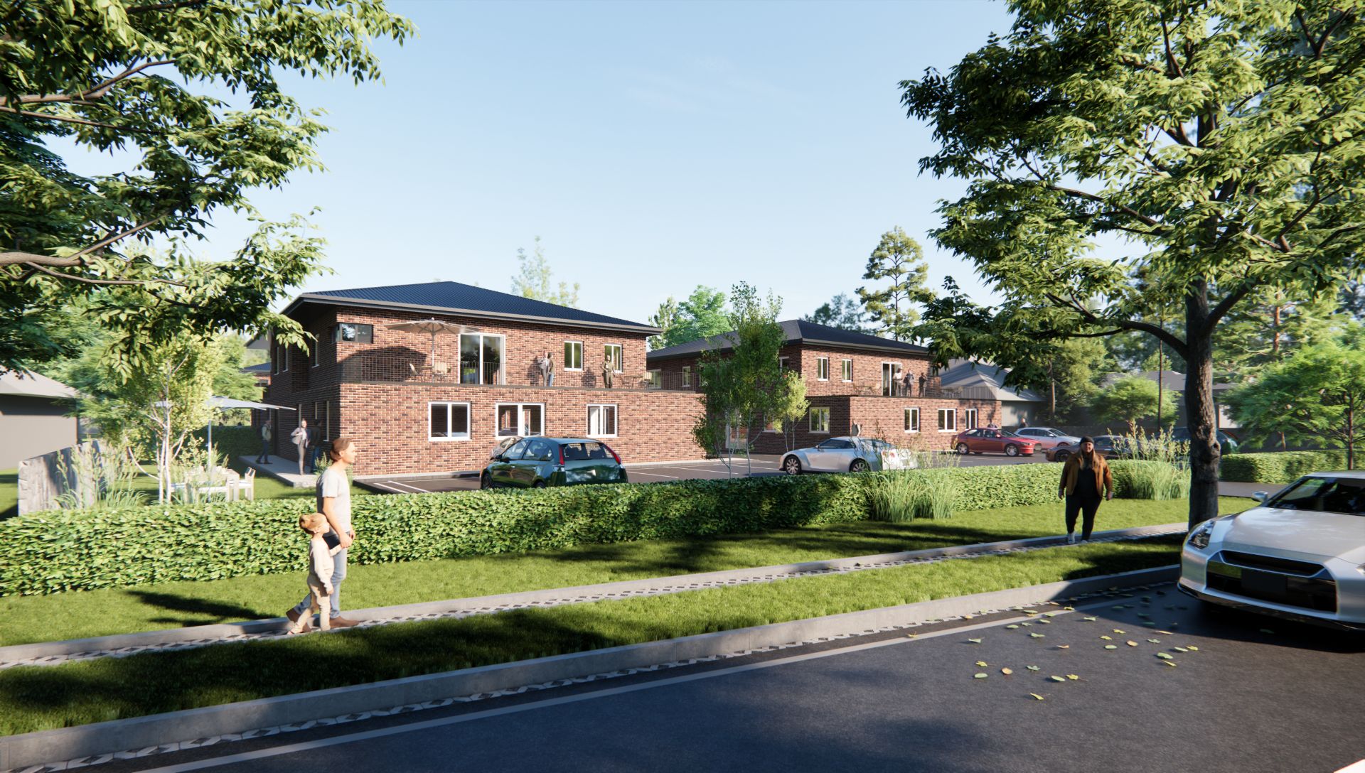 Zwei moderne Backsteinhäuser mit Autos auf Parkplätzen, Bäumen und Gehweg im Vordergrund.