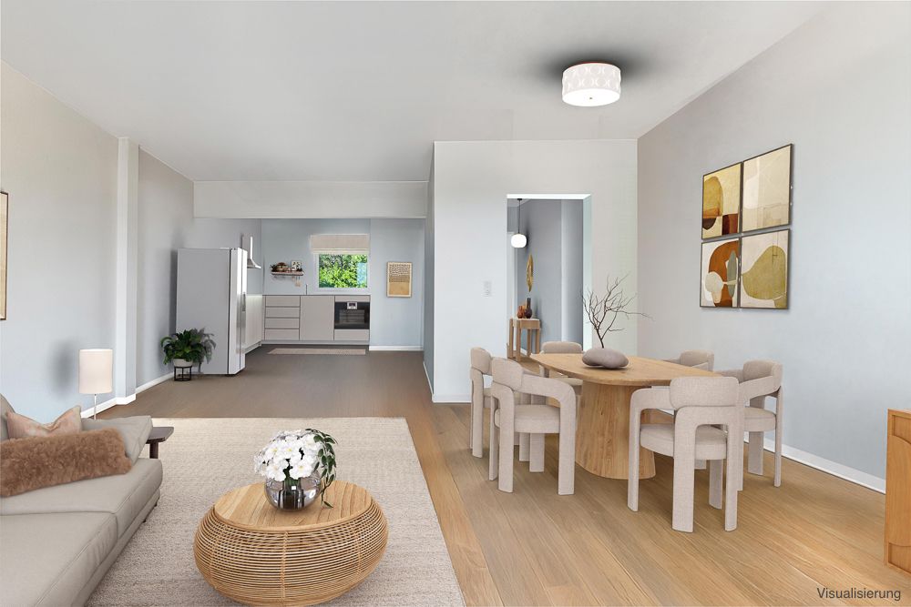 Moderne Wohnküche mit Esstisch, Sofa, Couchtisch und Wandbildern, helle Einrichtung.