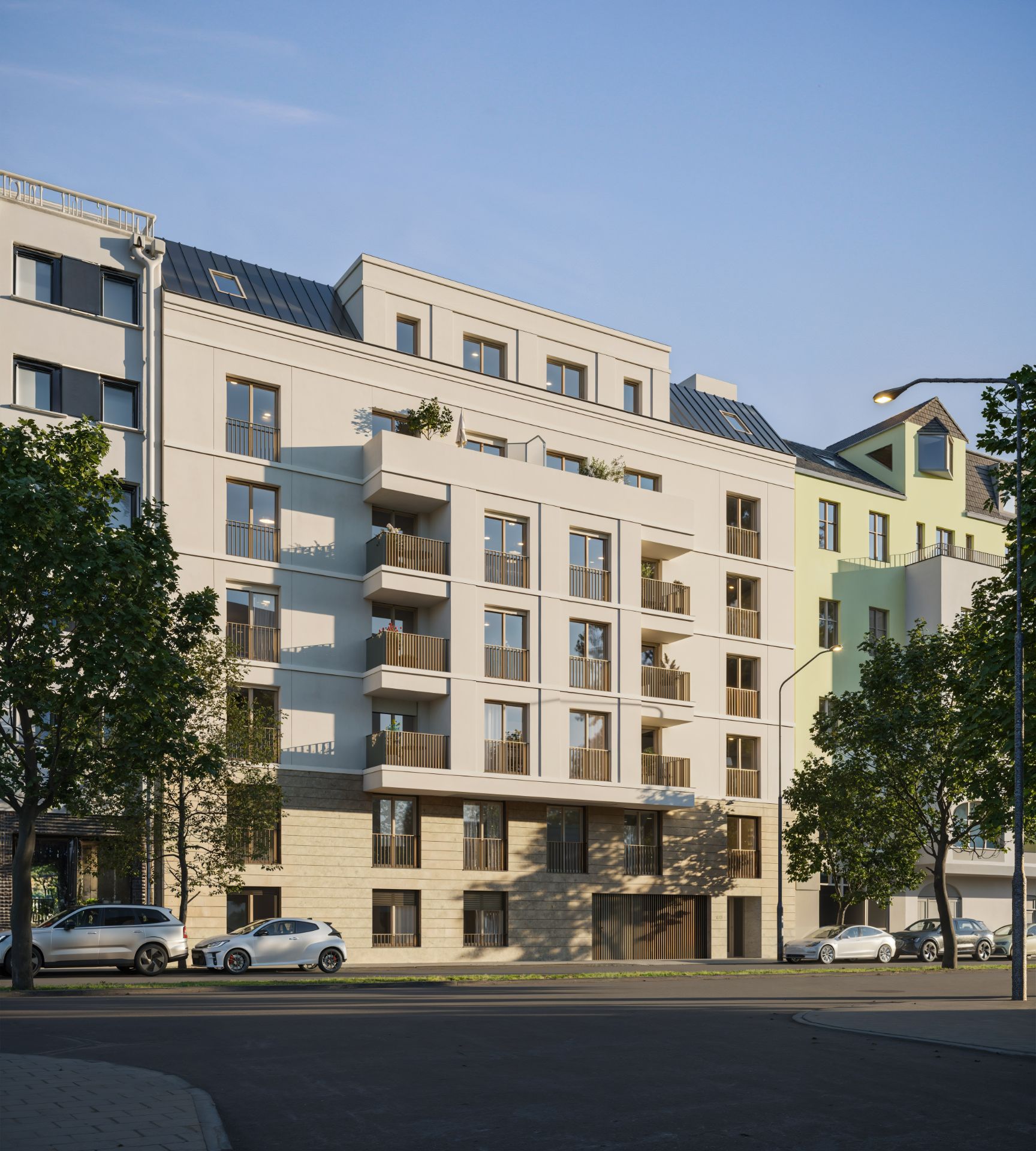 Mehrstöckiges Wohngebäude mit Balkonen und geparkten Autos vor dem Haus.