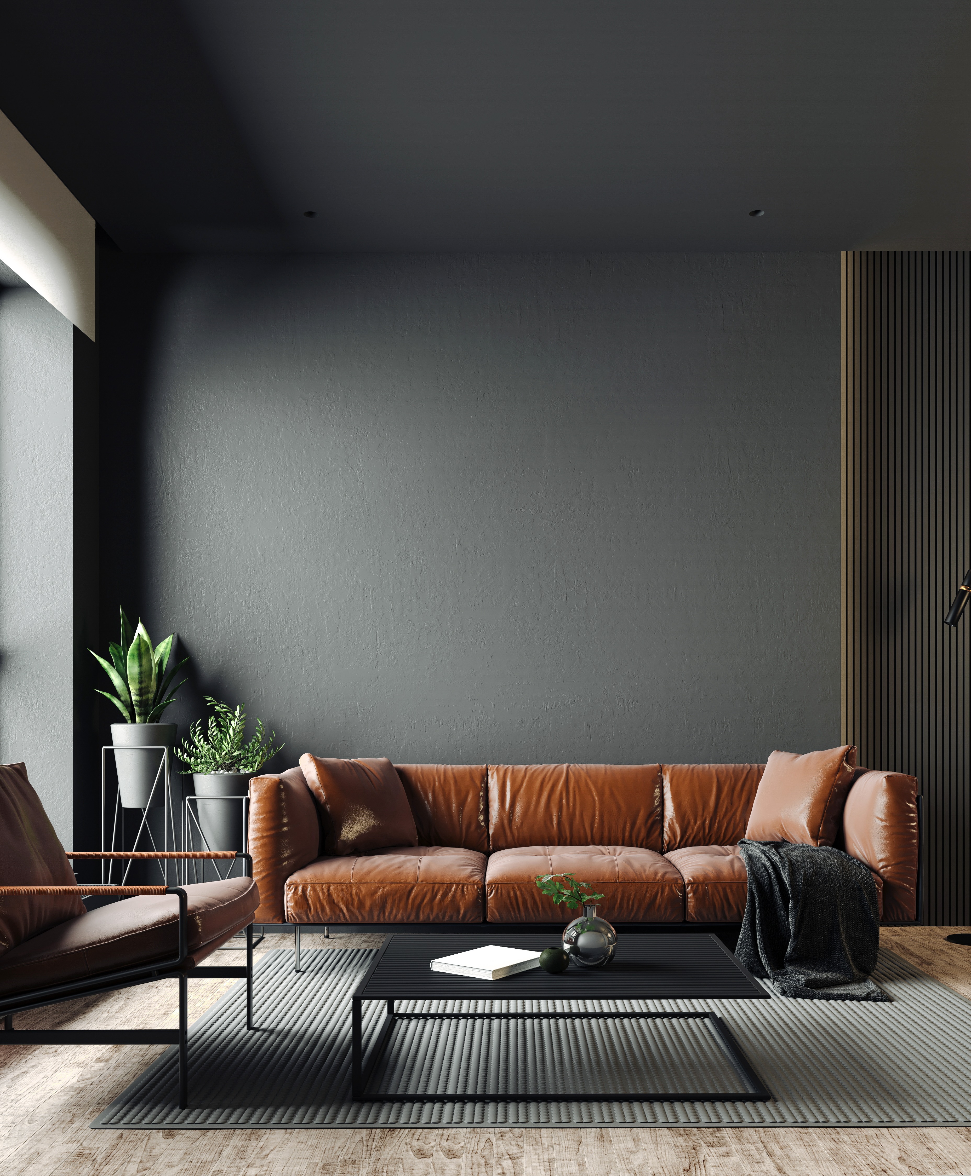Modernes Wohnzimmer mit braunem Ledersofa, Couchtisch und Zimmerpflanzen.