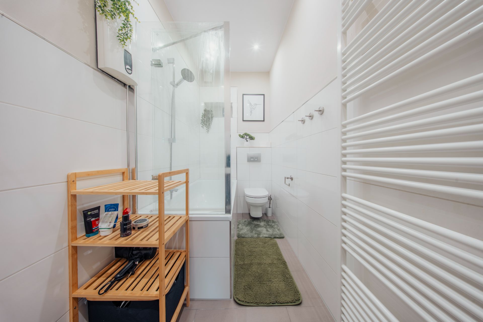 Modernes Badezimmer mit Dusche, Regal, WC und grünem Teppich.
