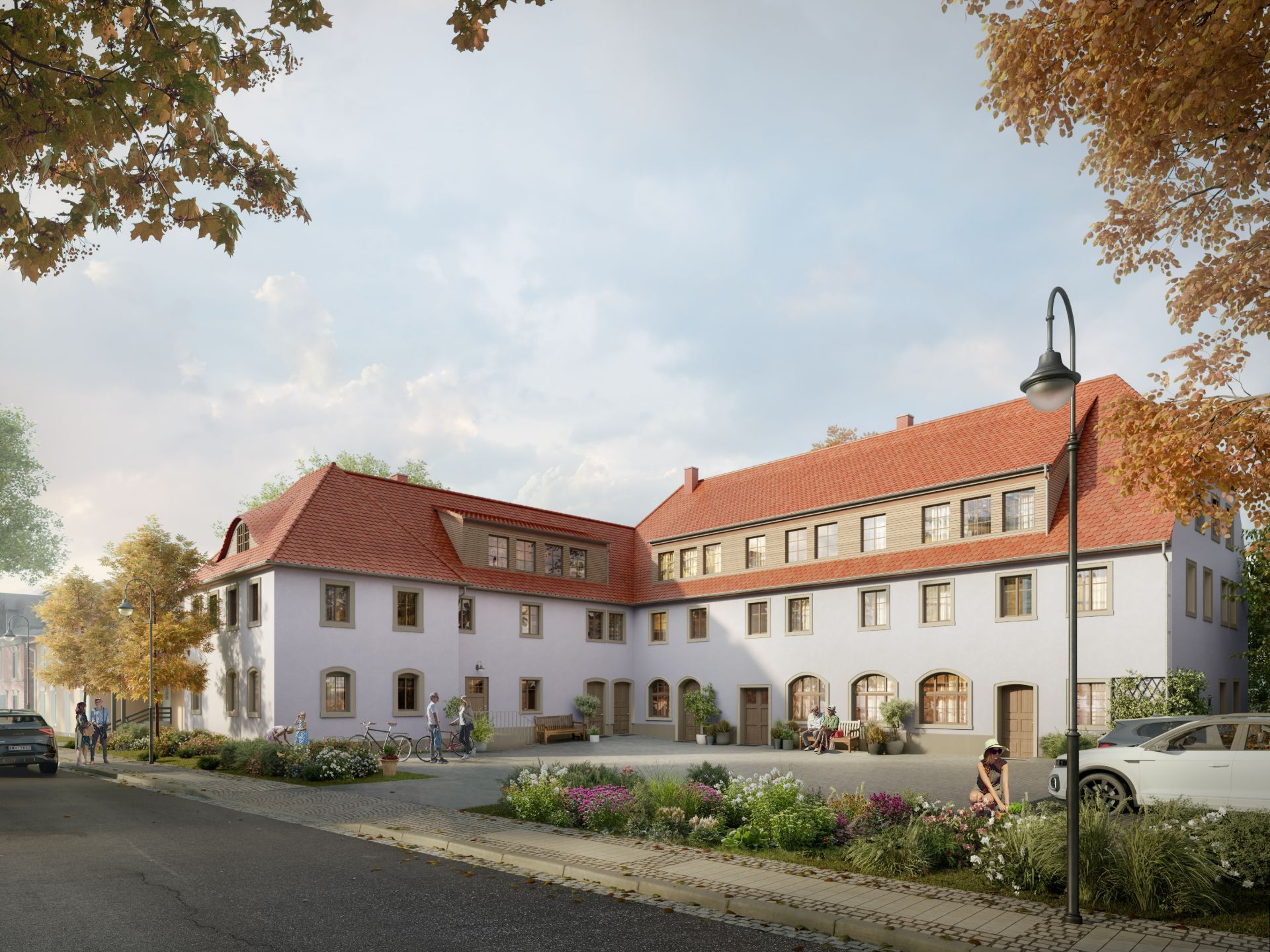 Mehrfamilienhaus mit rotem Dach und begrüntem Vorplatz an einer ruhigen Straße.