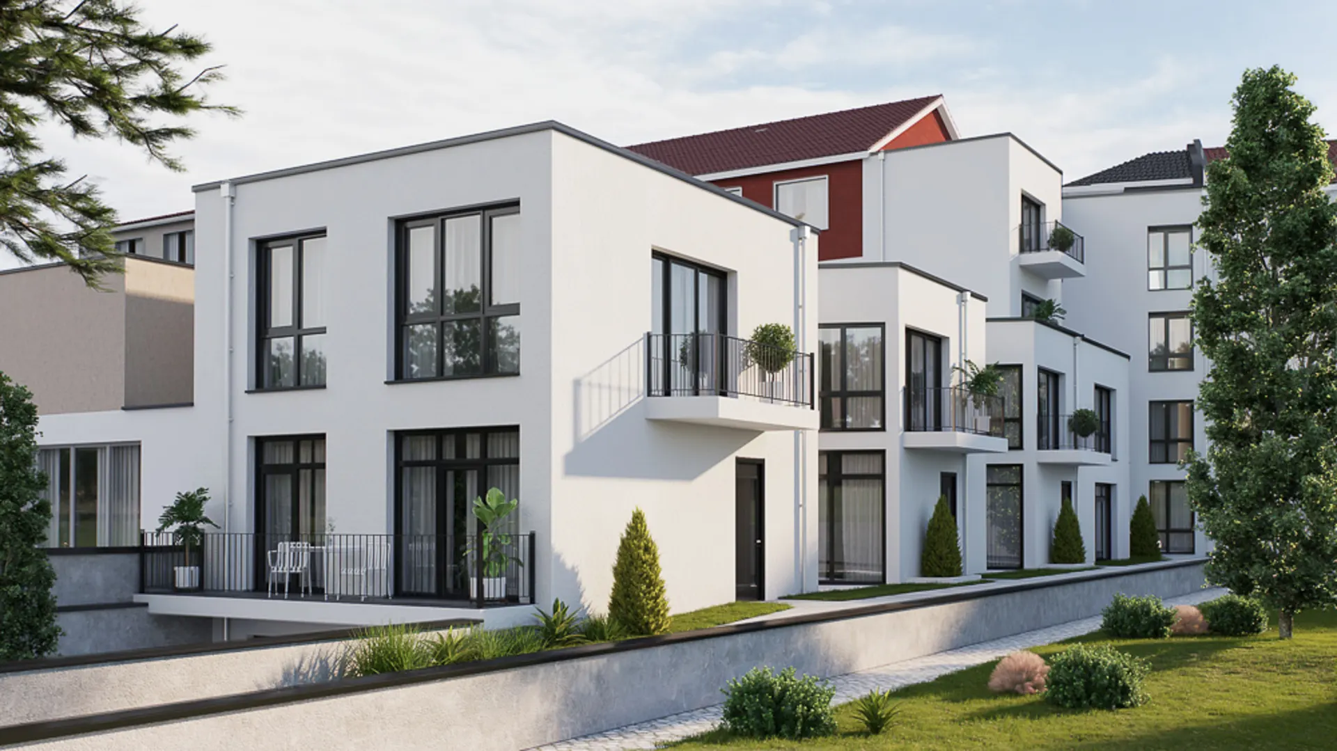 Moderne weiße Wohnhäuser mit großen Fenstern, Balkonen und Garten im Vordergrund.