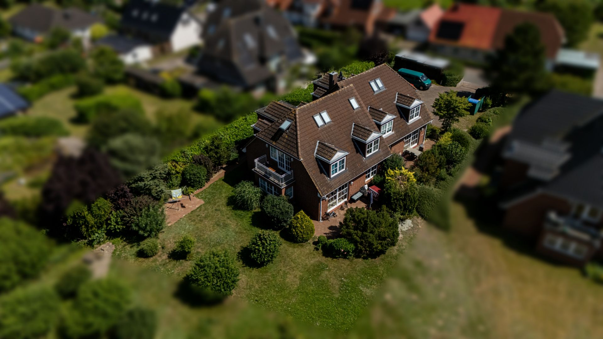 Luftaufnahme eines Wohnhauses mit Garten und umliegender Begrünung.