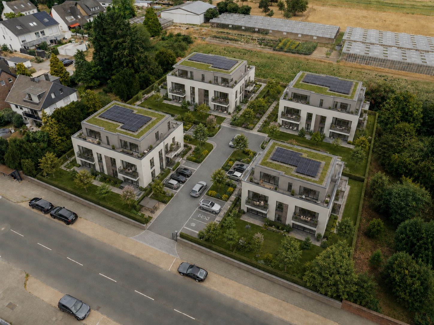 Vier moderne Wohngebäude mit begrünten Dächern und Solarpanels, umgeben von Gärten und Parkplätzen.