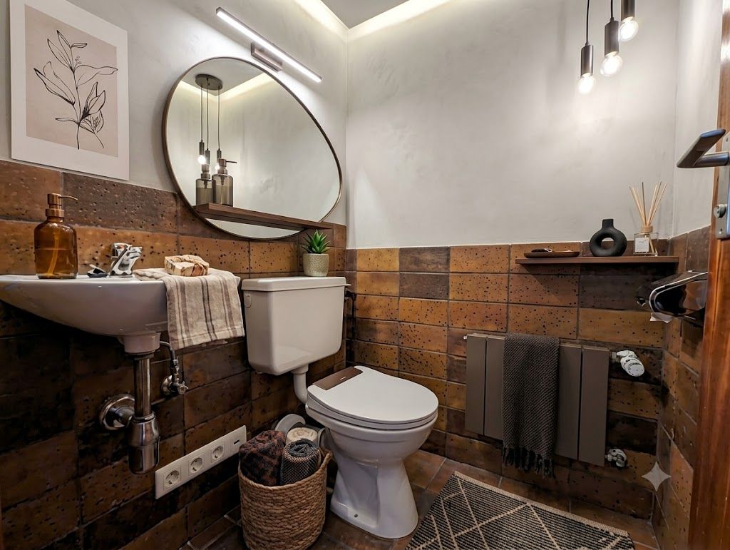 Kleines Bad mit WC, Waschbecken, Spiegel und Regal, dekoriert mit Pflanzen und Handtüchern.