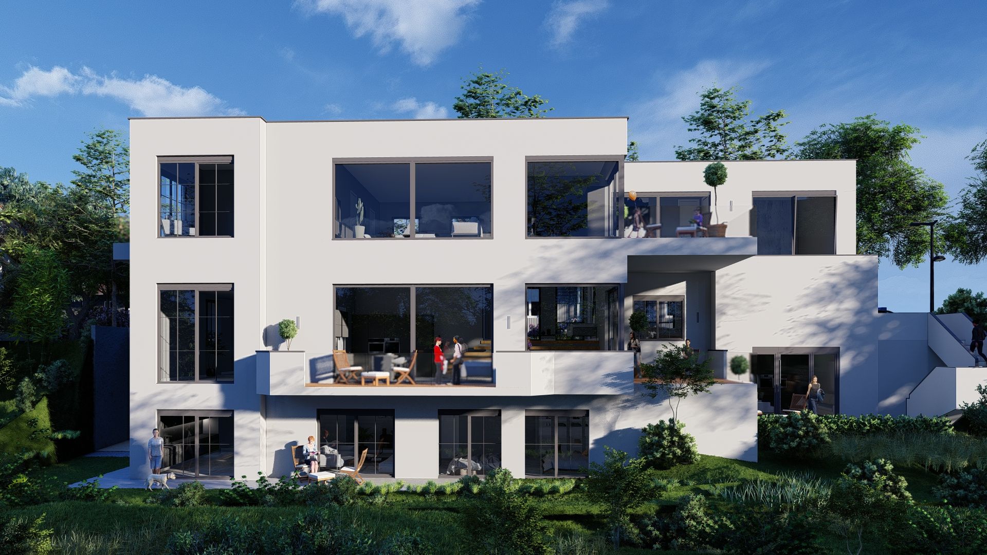 Modernes weißes Wohngebäude mit großen Fenstern und mehreren Terrassen, umgeben von Grünflächen.