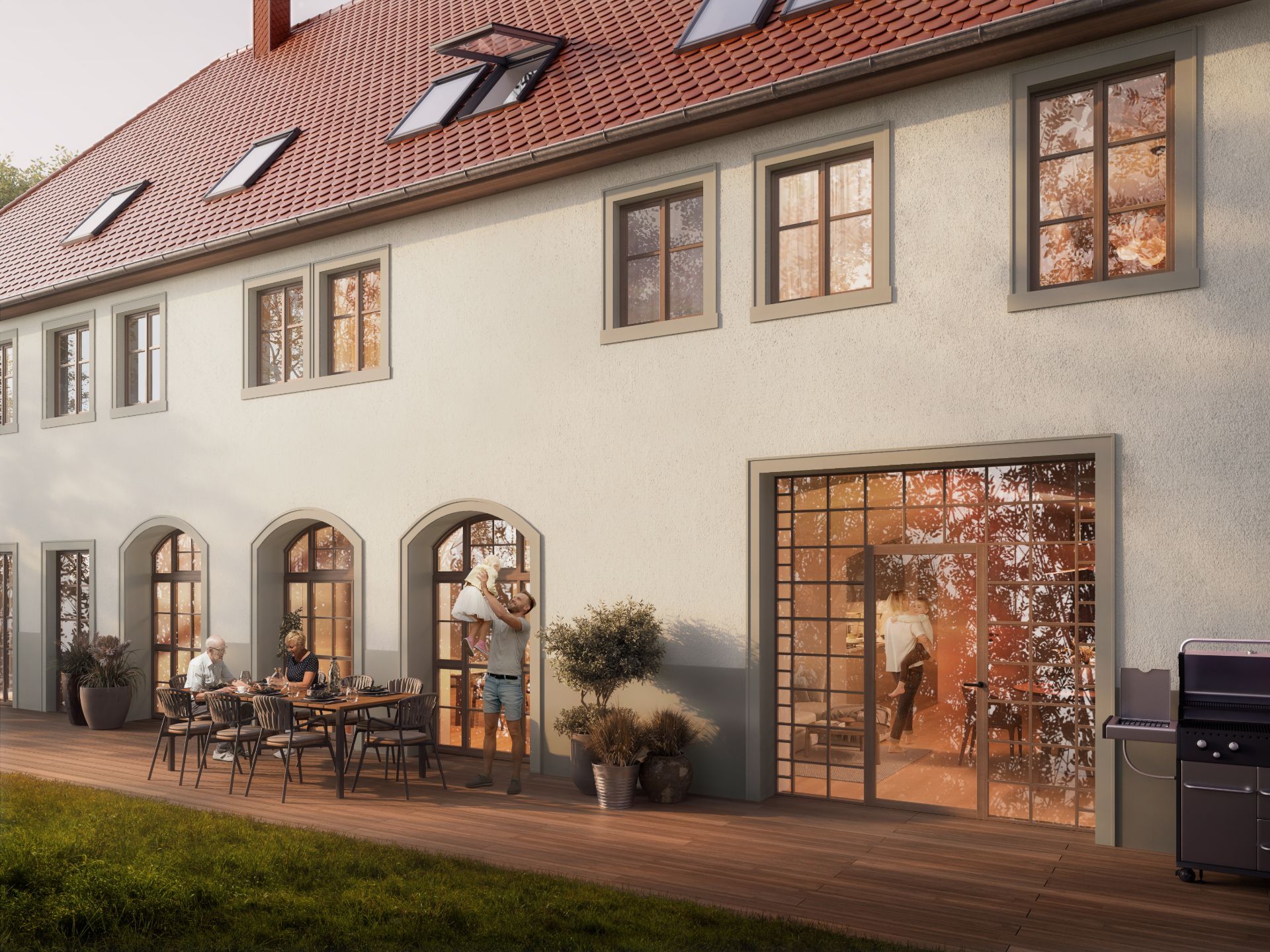 Hinterhof einer Wohnanlage mit Terrasse, Esstisch, Pflanzen und Menschen beim Essen und Spielen.