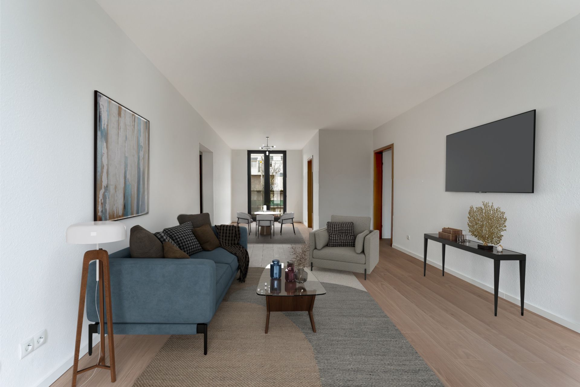 Modernes Wohnzimmer mit Sofa, Sessel, Fernseher und Esstisch im Hintergrund.