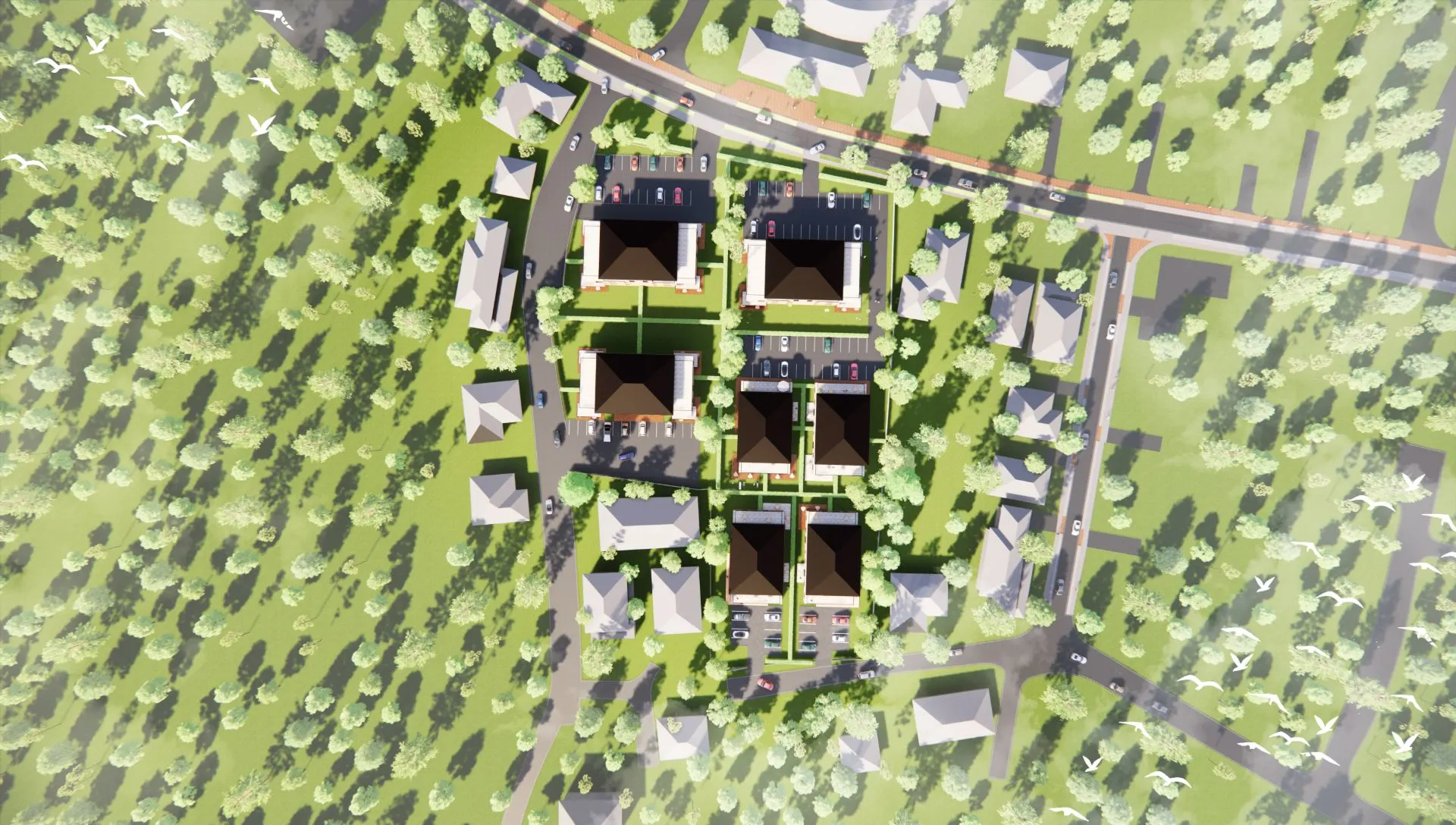 Luftaufnahme mehrerer Wohnhäuser mit Straßen, Parkplätzen und viel Grün.