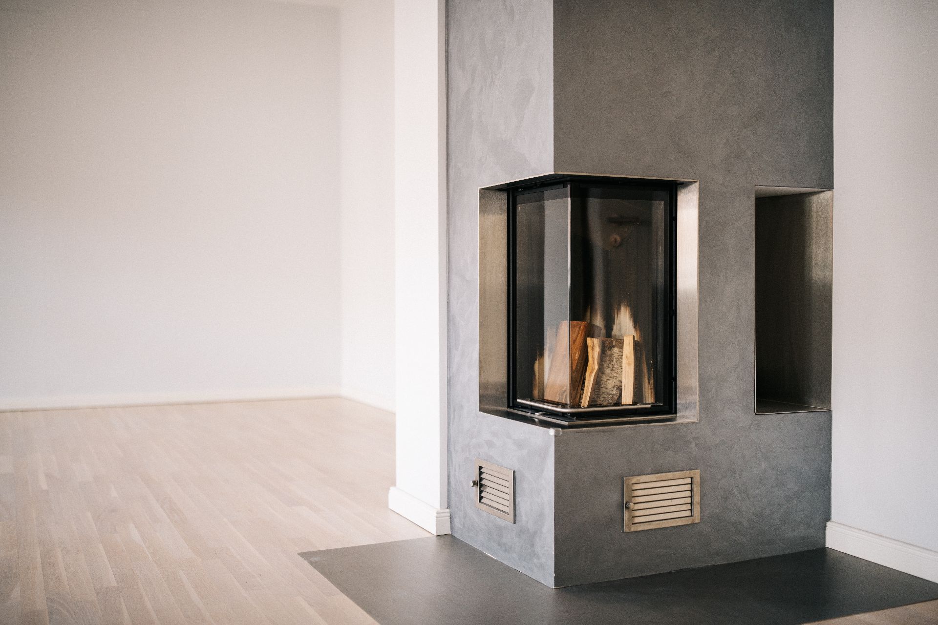 Moderner Kamin in einem hellen Raum mit Holzfußboden.