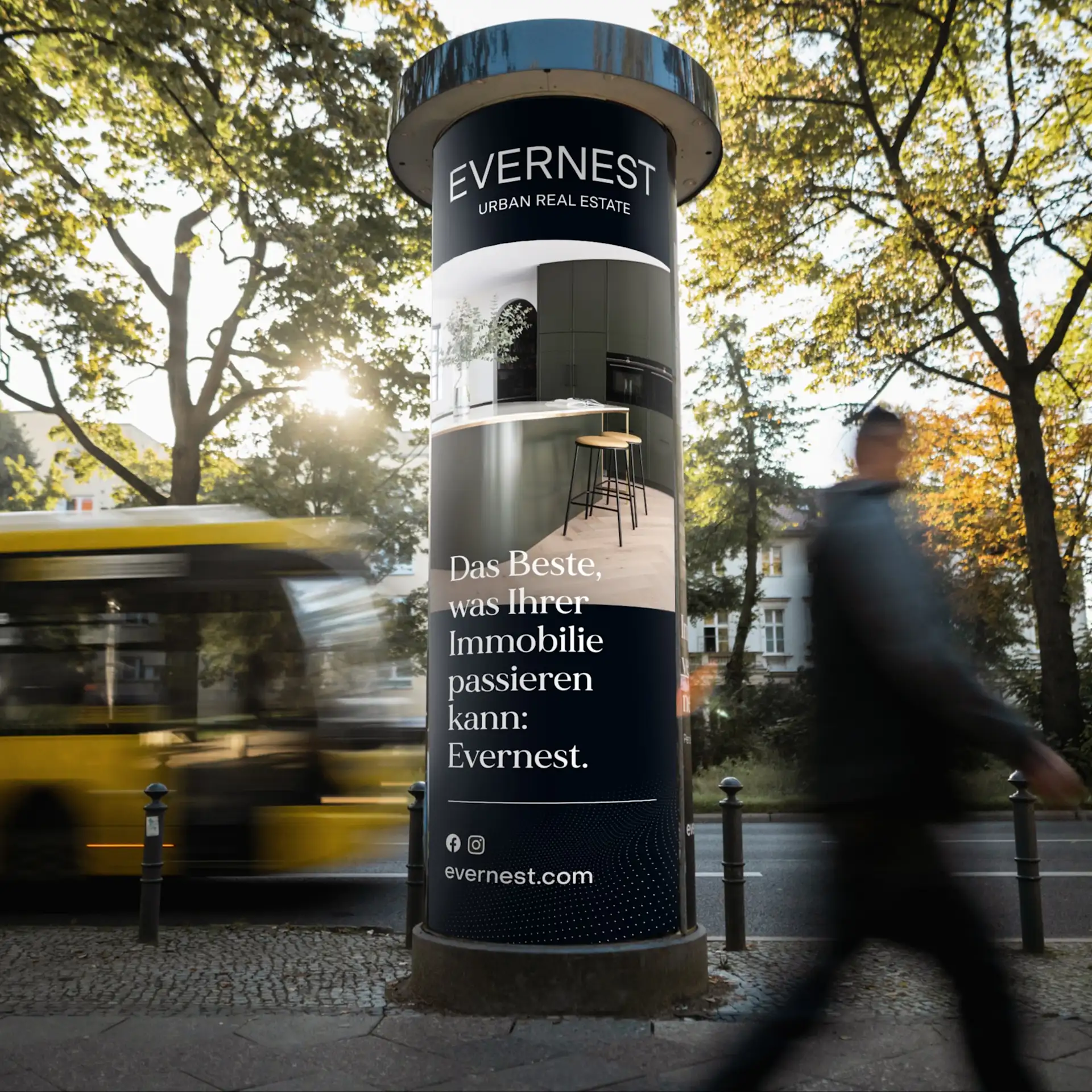 Poster mit moderner Wohnhaus-Abbildung und Text an einer hellen Wand, Person geht vorbei.