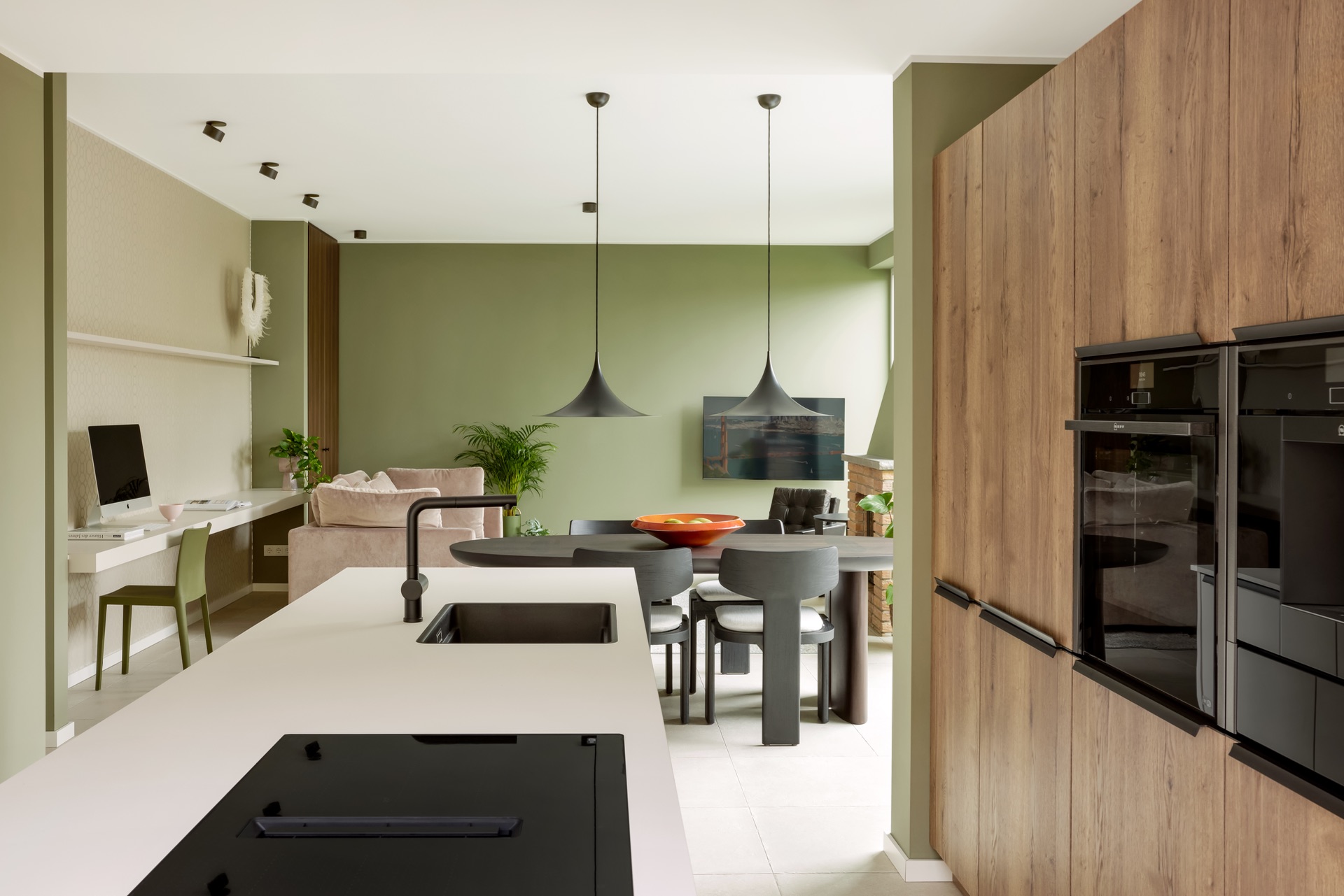 Moderne Küche mit Holzschränken, Essbereich und angrenzendem Wohnzimmer sichtbar.