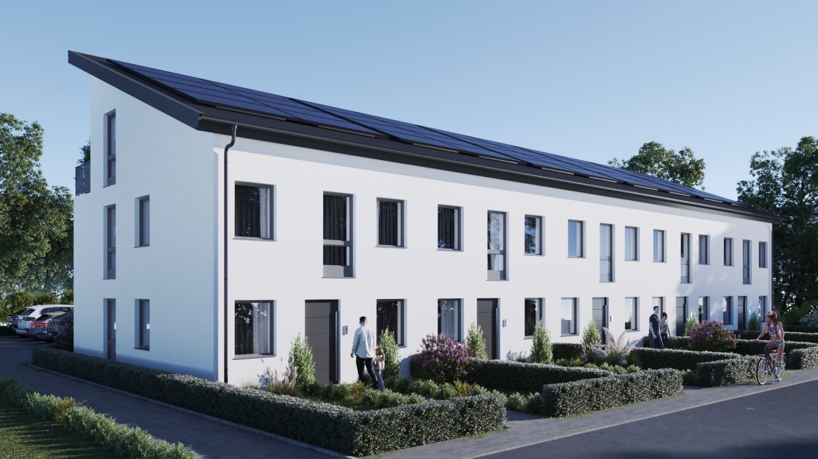 Modernes, zweistöckiges Reihenhaus mit Solarmodulen auf dem Dach und gepflegtem Vorgarten.
