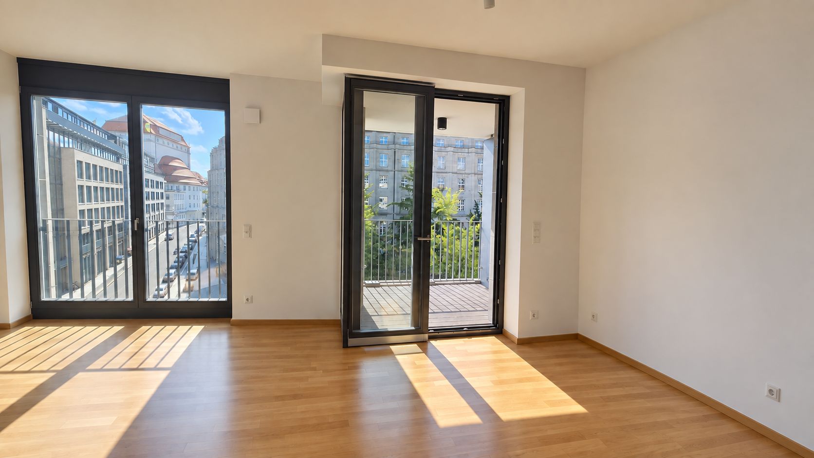 Helles Wohnzimmer mit großen Fenstern, Parkettboden und Zugang zu einem Balkon.