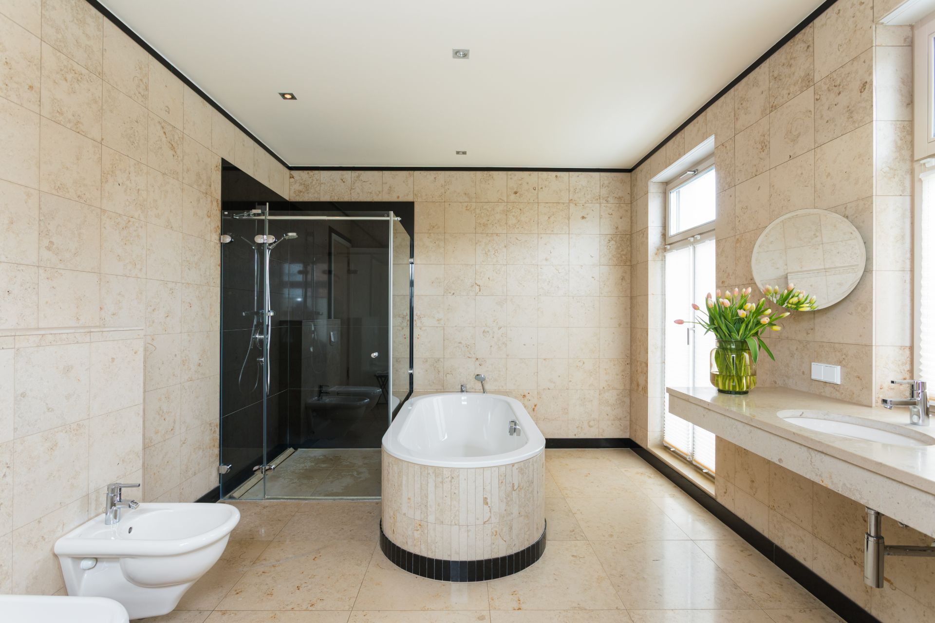 Modernes Badezimmer mit freistehender Badewanne, großer Dusche und Doppelwaschbecken.