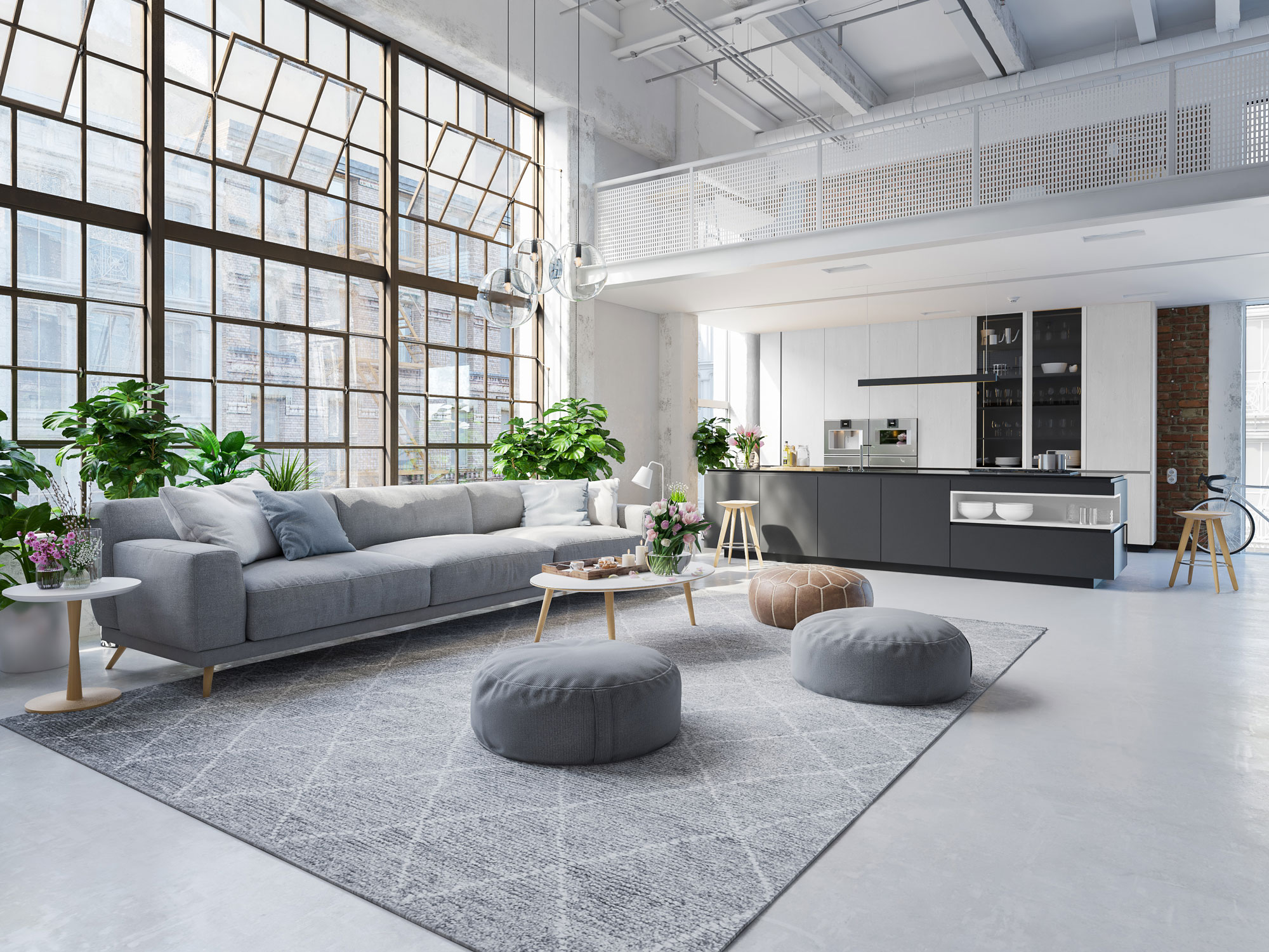 Helles Wohnzimmer mit grauem Sofa, großen Fenstern, Teppich und moderner offener Küche.