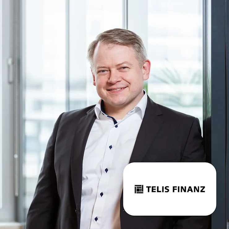 Ein Mann im Anzug steht vor einem Fenster, rechts unten ist das Telis Finanz Logo.