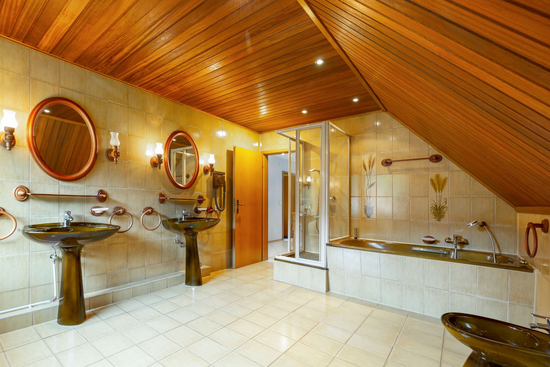 Großes Badezimmer mit zwei Waschbecken, Badewanne, Dusche und Holzdecke.