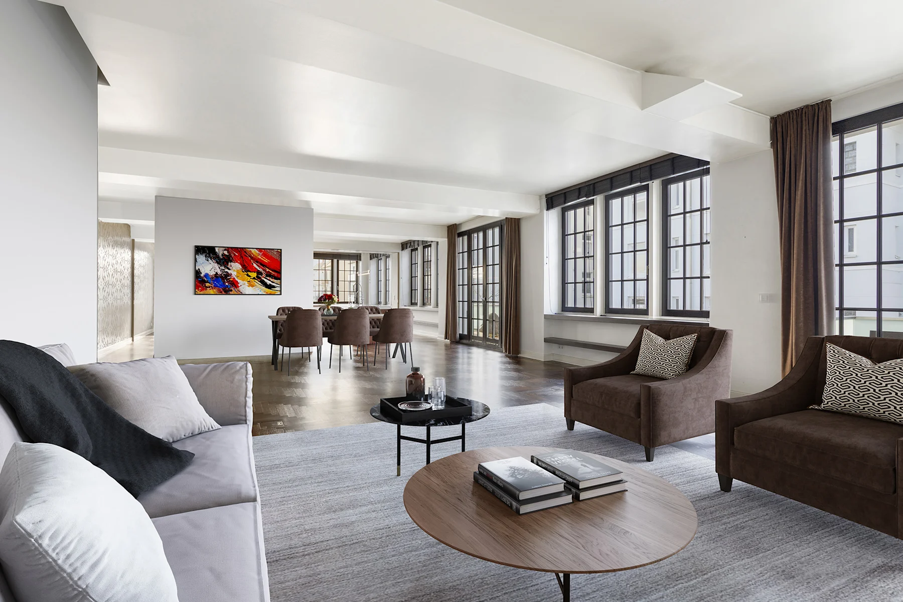 Modernes Wohnzimmer mit Sofa, zwei Sesseln, Couchtisch und großem Essbereich im Hintergrund.