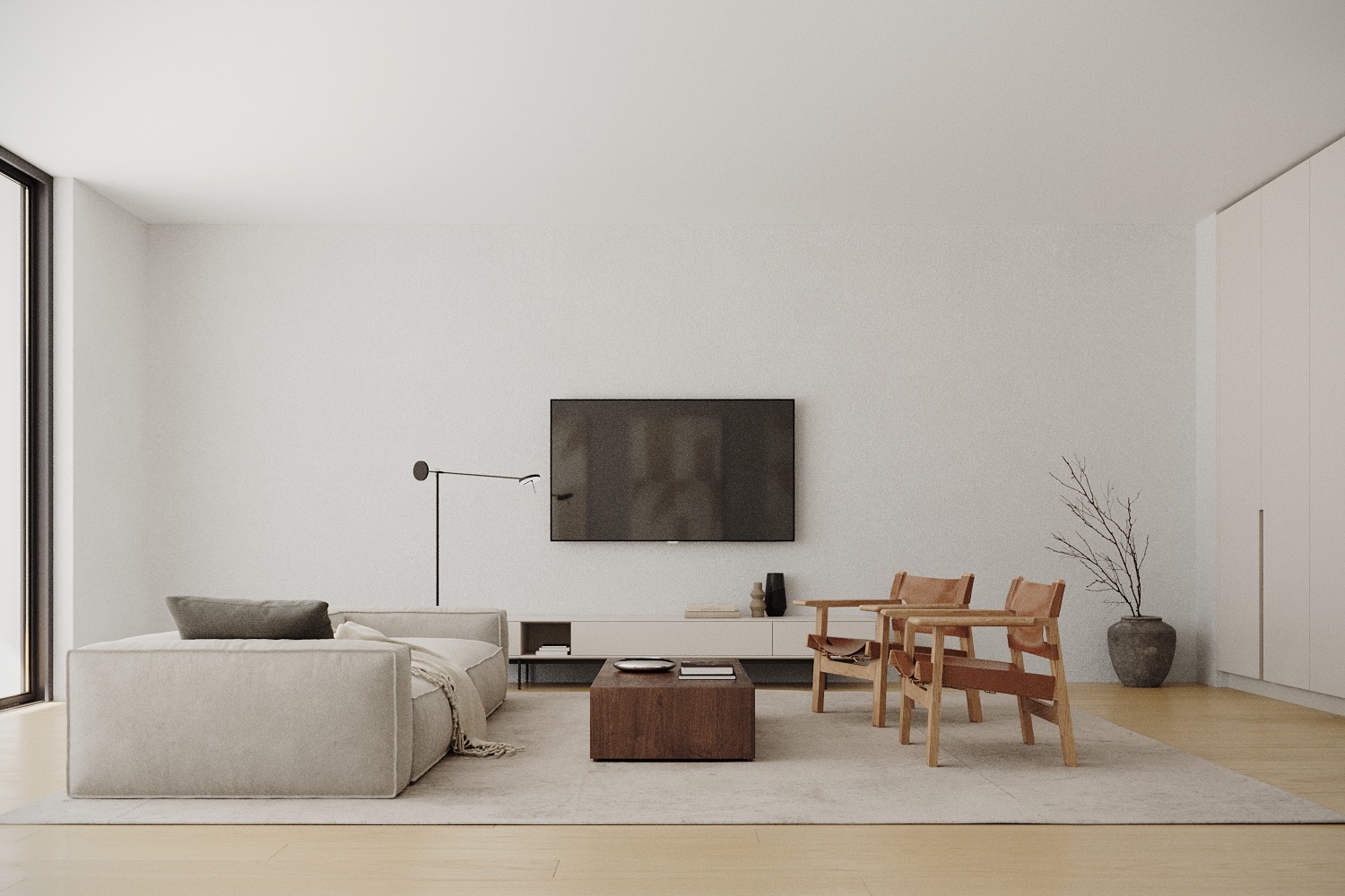 Modernes Wohnzimmer mit Sofa, zwei Stühlen, Couchtisch und Fernseher an der Wand.