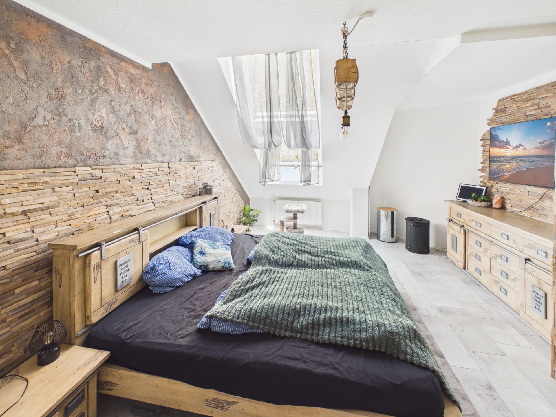 Modernes Schlafzimmer mit Doppelbett, Holzdetails und Fenster mit Vorhängen.