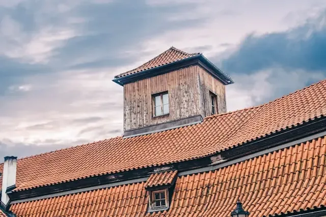 an old brown roof and their owner wondering the cost of getting a new roof