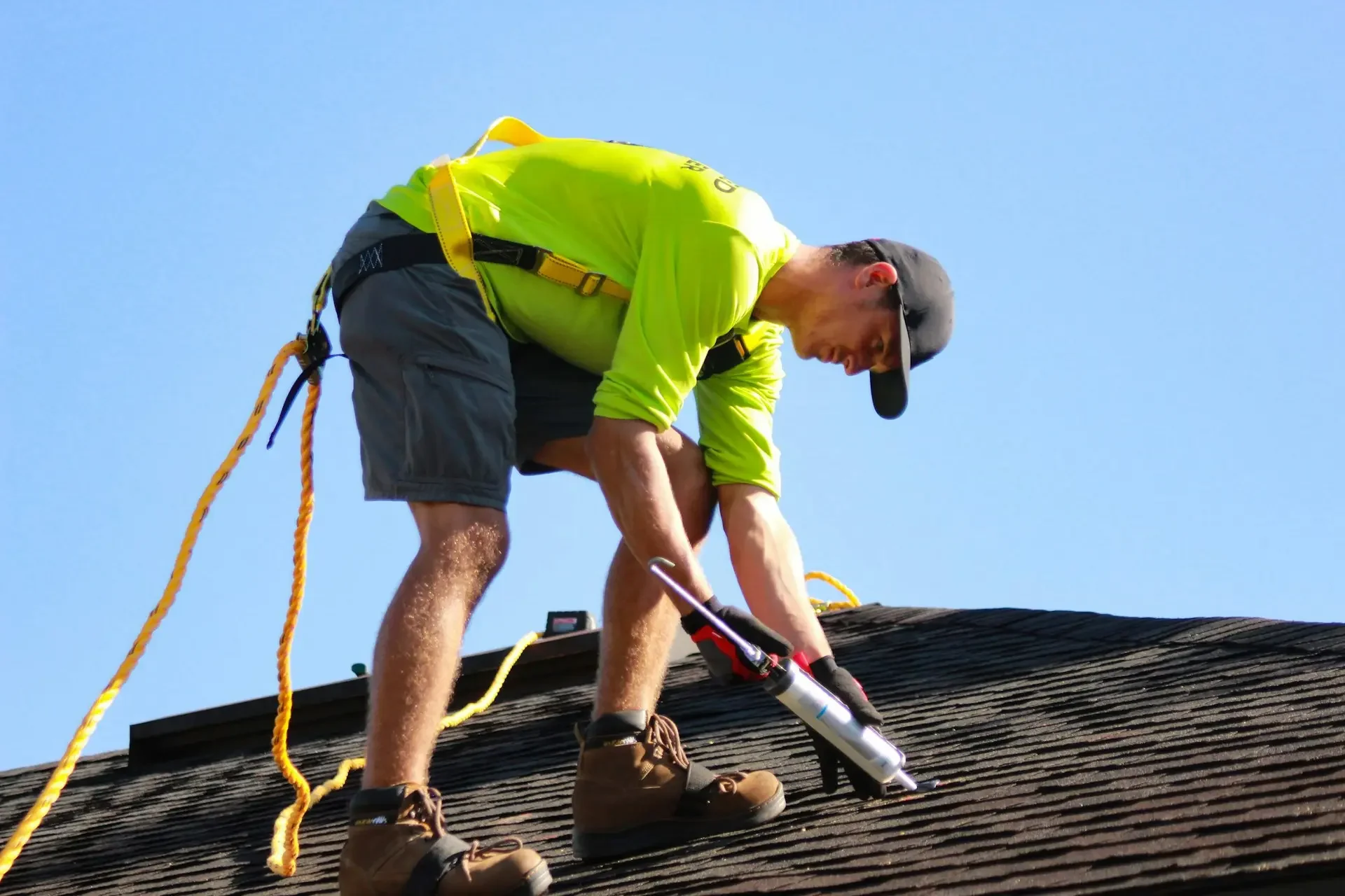 A professional from Taj Roofing is replacing a broken shingle in florida with a new one