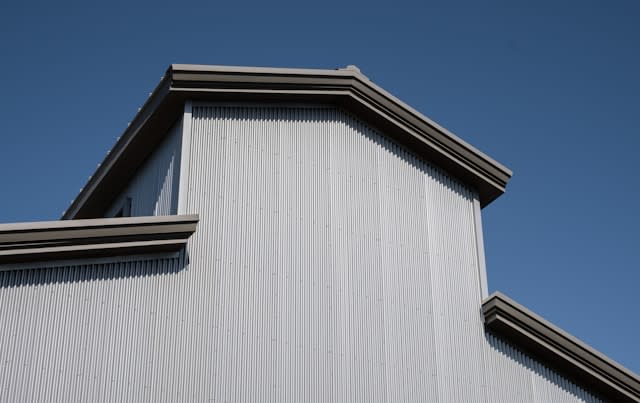 Off white metal  and a blue sky roof installed by Tajroofing