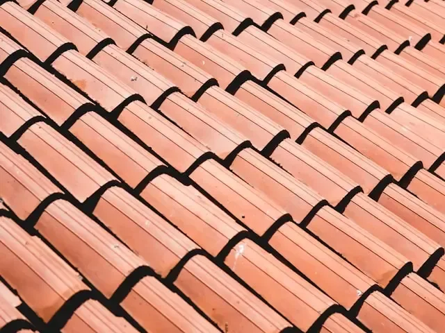 A brown shingle roof before installing a blue tarp by Taj roofing services