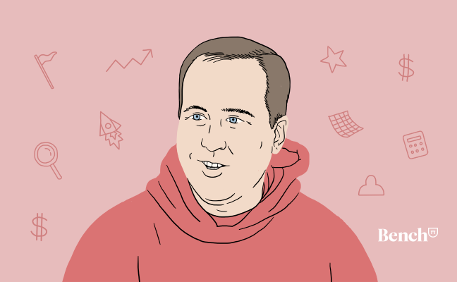 David Cohen in a red hoodie with dollar signs, rocket ships, and other small objects around him.