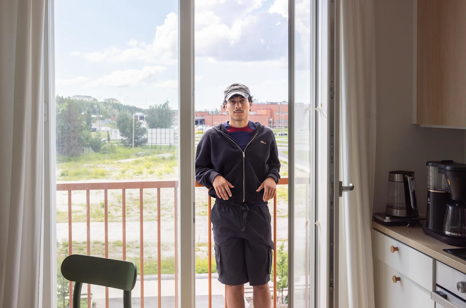 Jasir Osman, known as Risanaamio, on the French balcony of his Joo Kodit home in Turku.