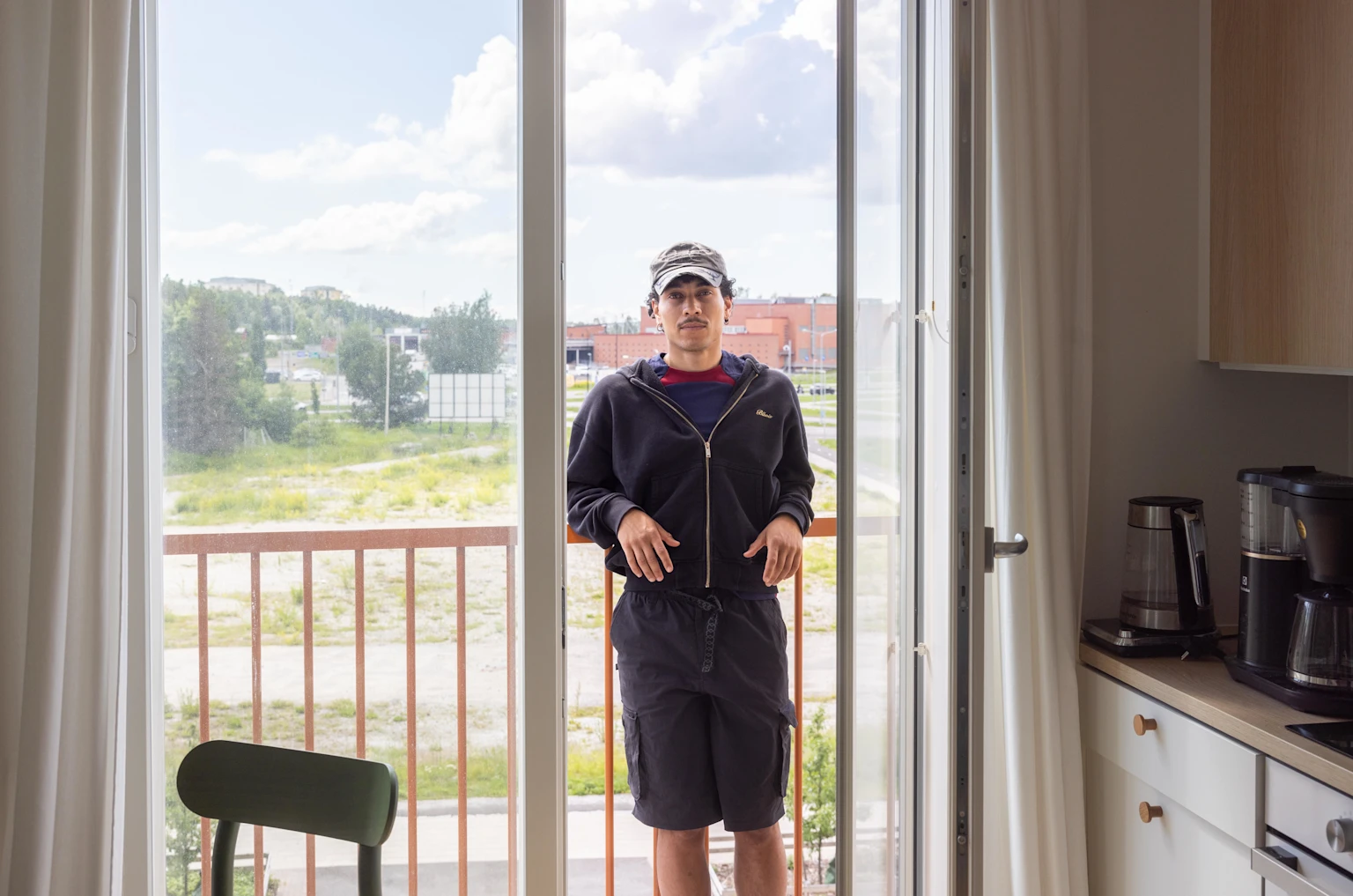 Jasir Osman, known as Risanaamio, on the French balcony of his Joo Kodit home in Turku.