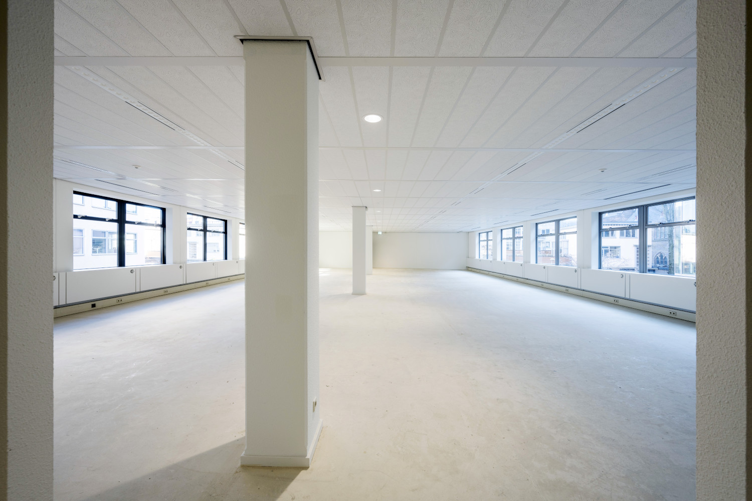 an empty room with white walls and floors
