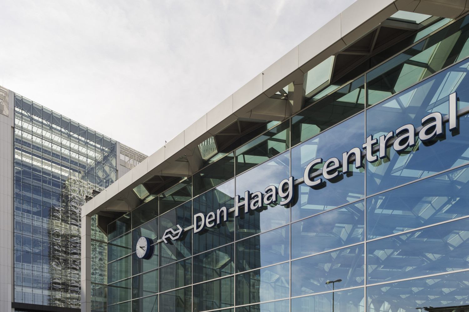 a large glass building with a sign on it