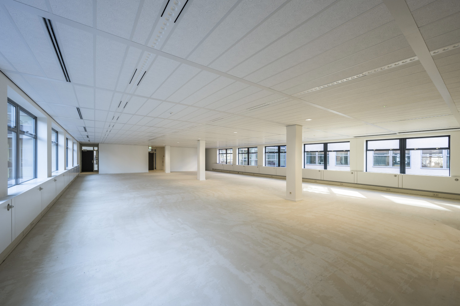 an empty room with white walls and floors