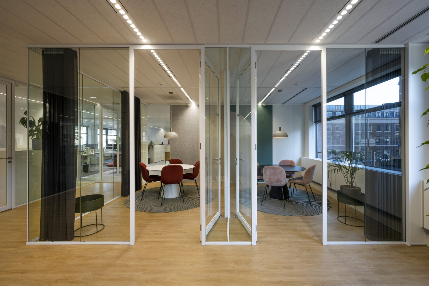 a room with a lot of glass walls and chairs