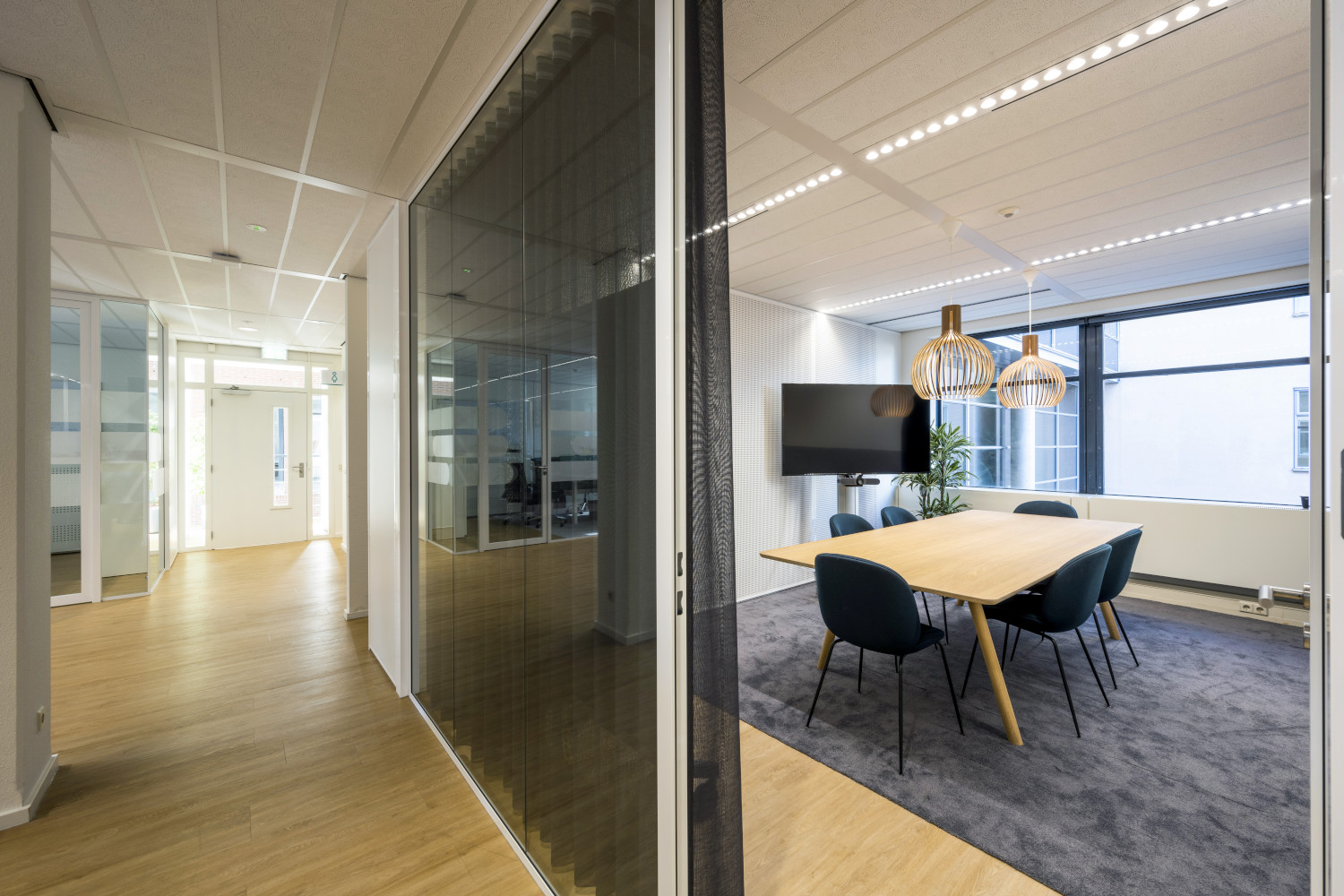 a room with a wooden table and chairs