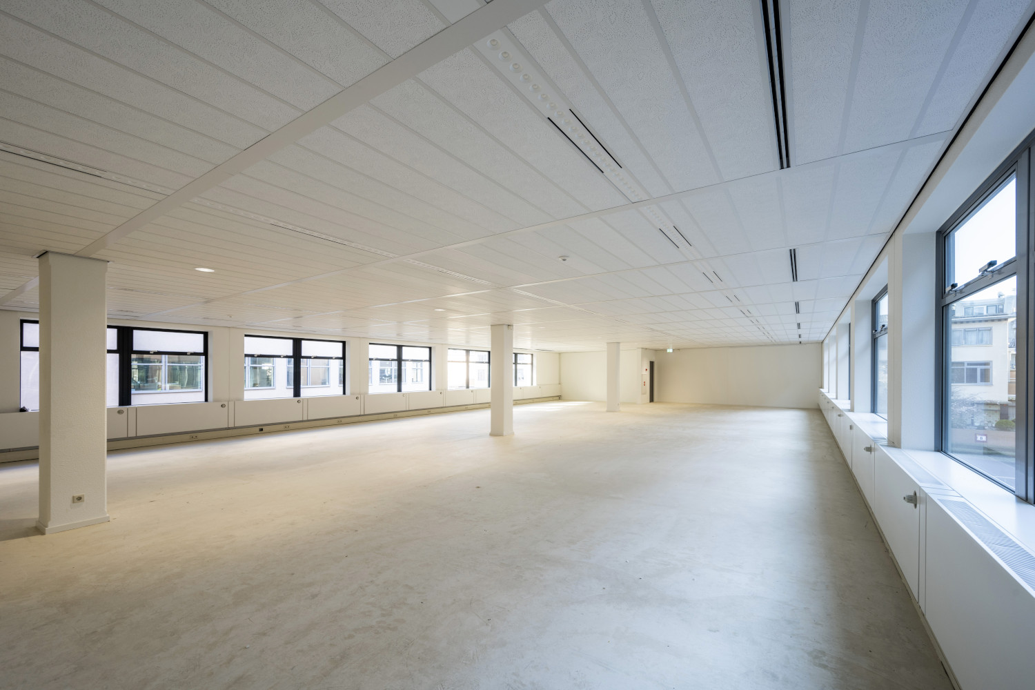 a large empty room with a lot of windows