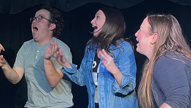 A group of 3 improvisers screaming in surprise!