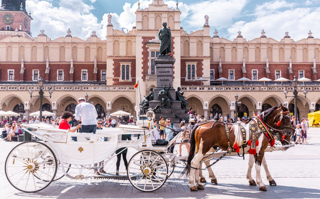 Beautiful Krakow Market Square full of tourists during the Summer season
