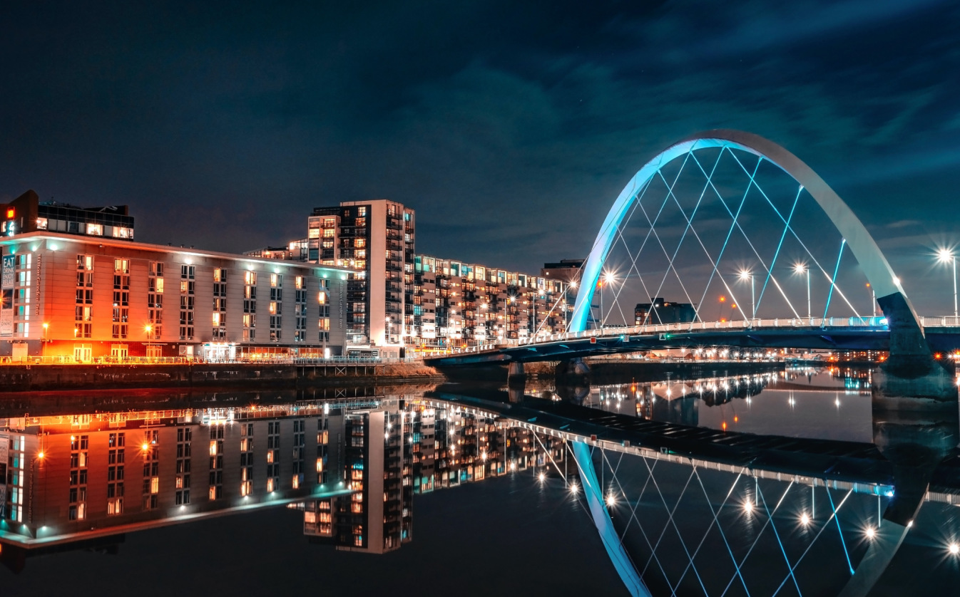 Cityscape of Glasgow at night, featuring The Clyde Arc