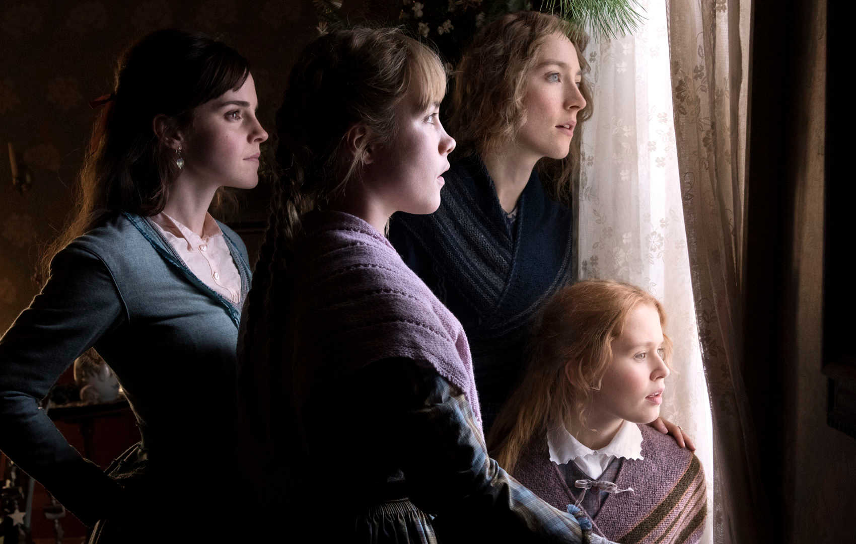 Four young women gathered around a window, looking out. The main characters of Little Women.