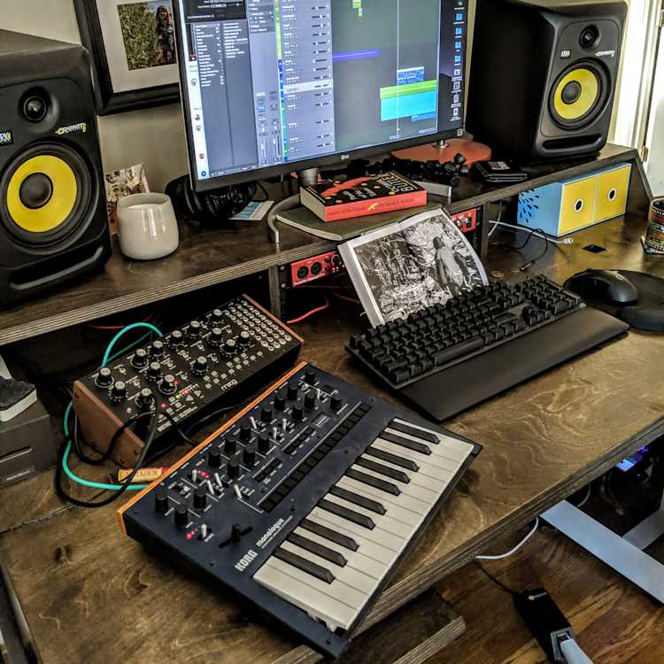 At the Mountains of Madness album cover, black text on a backdrop of huge antarctic mountains barely seen through a snowy blizzard.