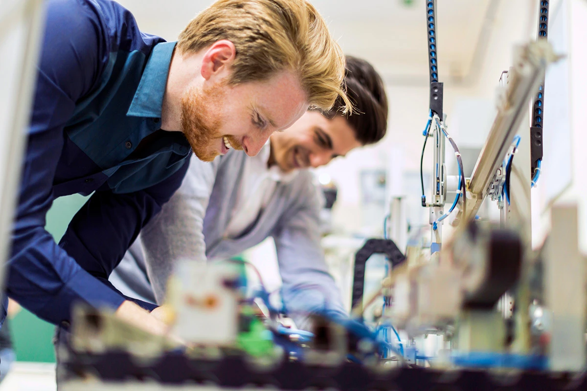 Two men working on electrical equipment